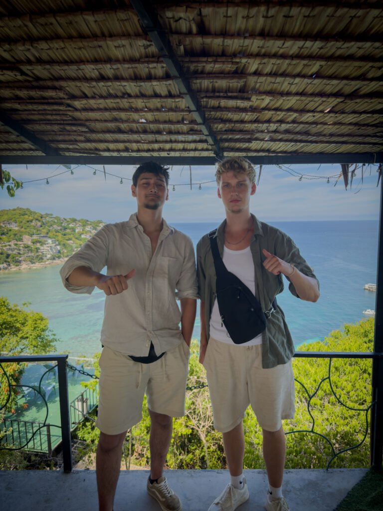 Two guys standing on a viewpoint.
