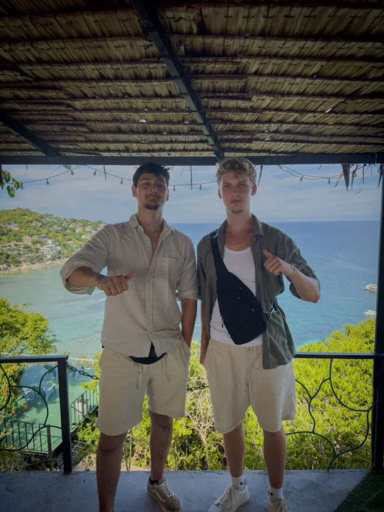 Two guys standing on a viewpoint.