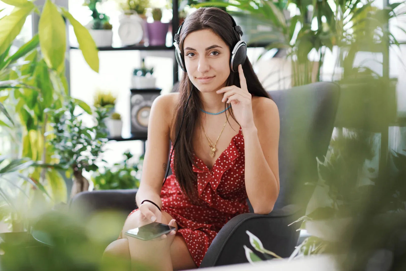 Woman relaxing at home and using a smartphone