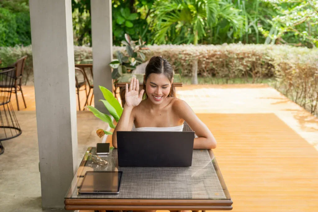 Young woman working on laptop in the restaurant